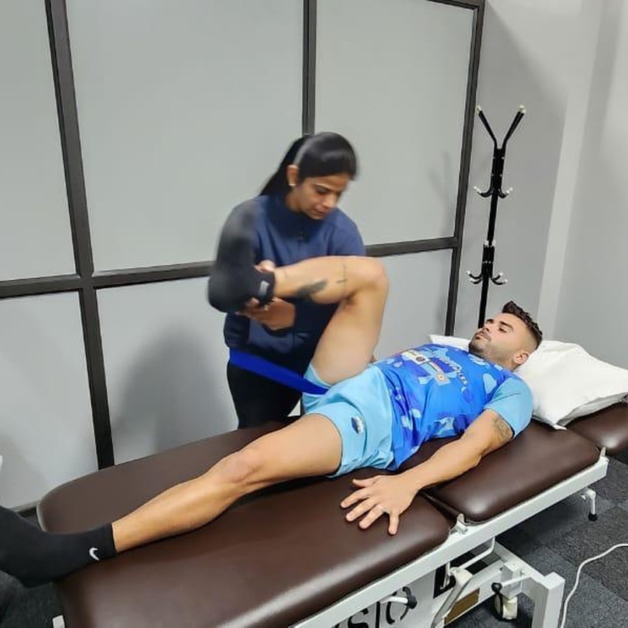 Physiotherapist treating patient on table